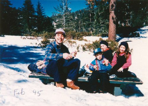 Family plays in snow
