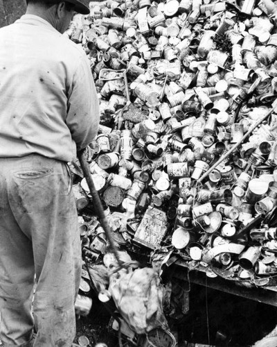 A mountain of cans meets a sorter at by-products plant