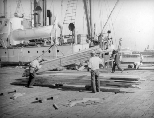 Crane and lumber at Los Angeles Harbor