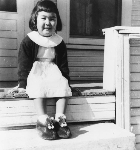 Japanese American girl on porch