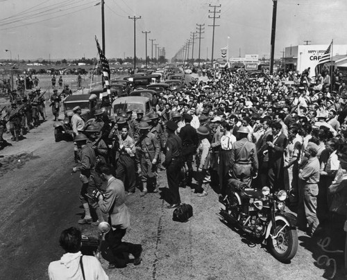 Troops clear away a crowd of strikers