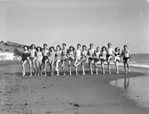 Group of acrobats on the beach, view 2