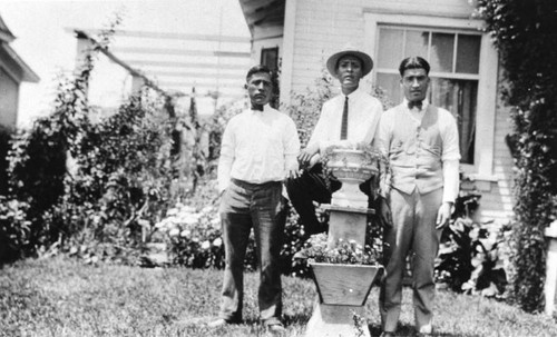 Mexican American brothers in front of home