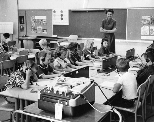 First grade students get lesson from tape recorder