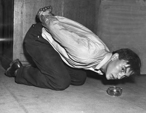 Young man demonstrates his punishment at reformatory