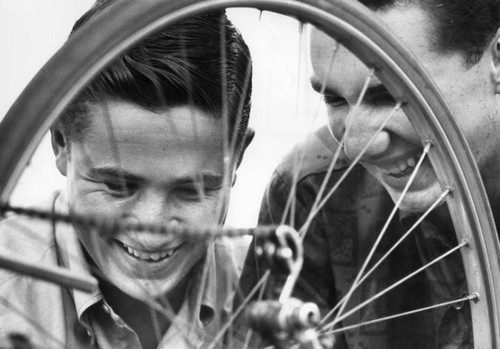 George Hull and Bob Fuller inspect bike wheel