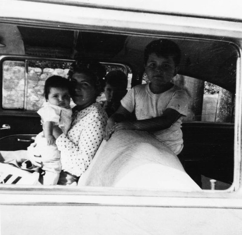 Mexican American women in car with children