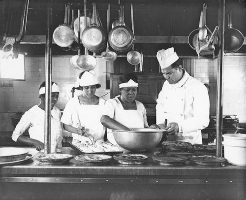 Jack Dempsey and cooks in restaurant