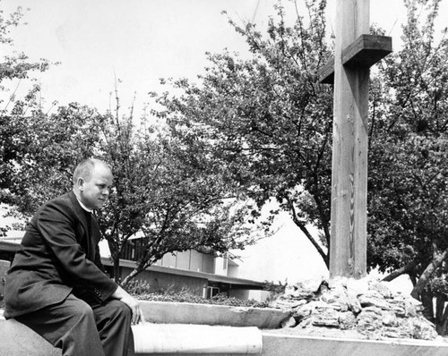 The Rev. Kenneth J. Olson studies architect's plans