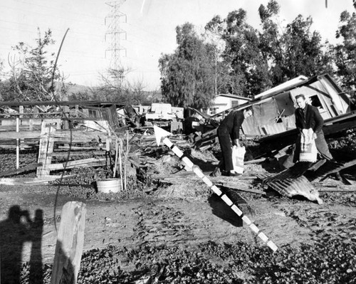 Swath (arrow) cut by runaway bulldozer, left, through yard