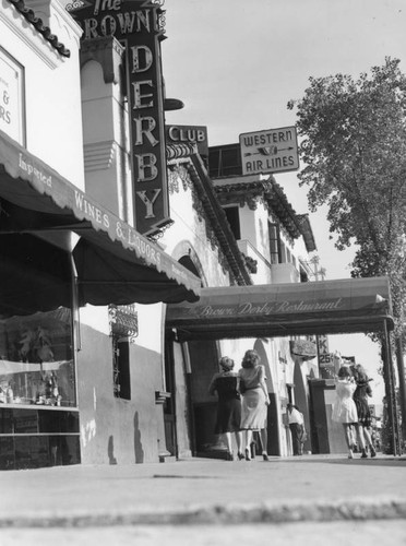 Pedestrians on the sidewalk by the Brown Derby