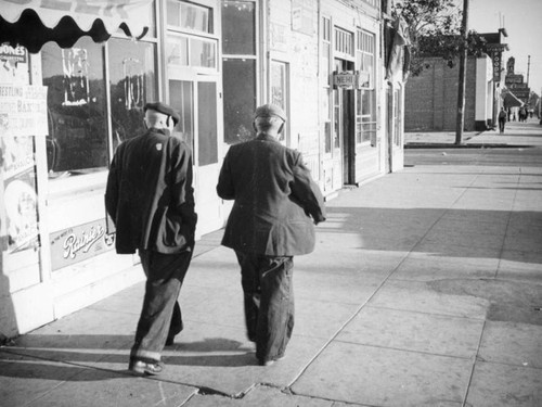 Men on sidewalk, Oxnard, Calif