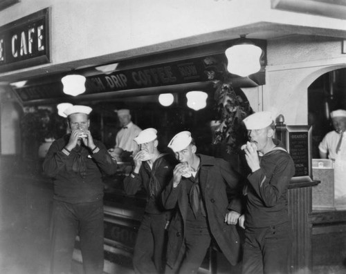 Sailors eating hot dogs at The Pike