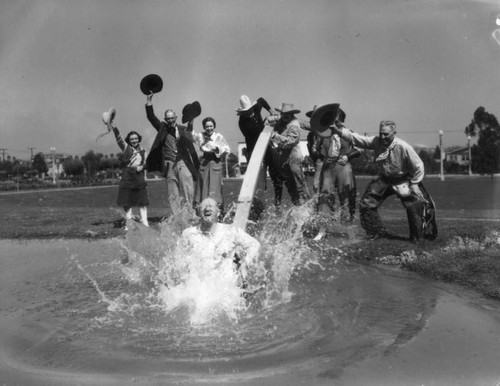 Parade participant gets dunked in pond