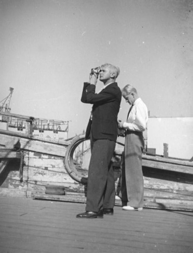 Herman Schultheis takes a picture on a movie set pirate ship