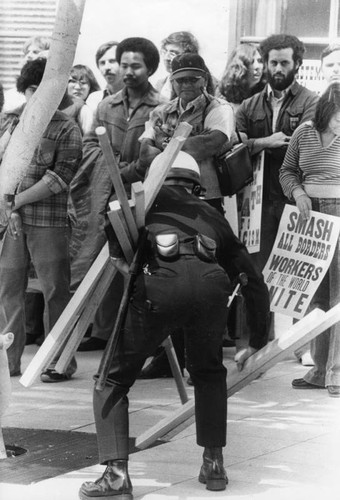 Demonstrators relinquish poles and sticks