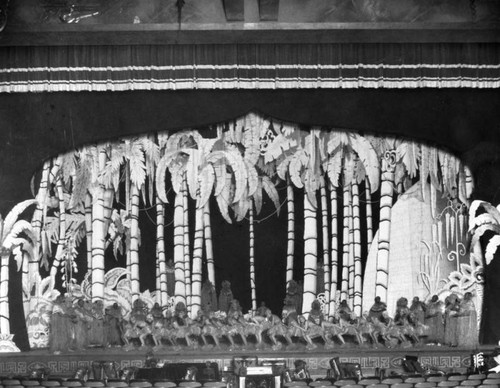 Dancers and palm trees on stage