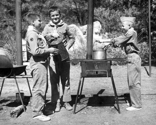 Boys cook outdoor meals