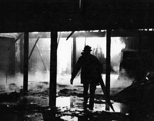 Fireman is framed by flames that swept Van Nuys market