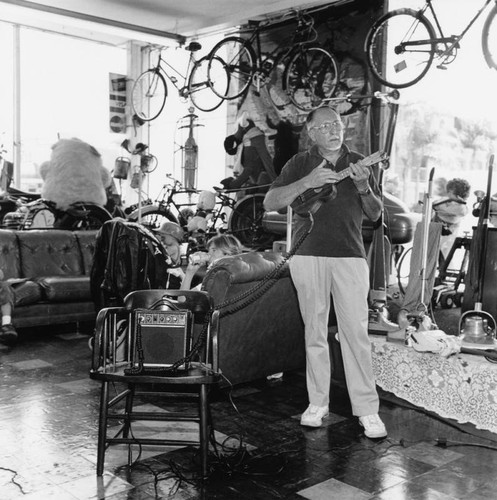 Ukulele player inside shop, San Pedro