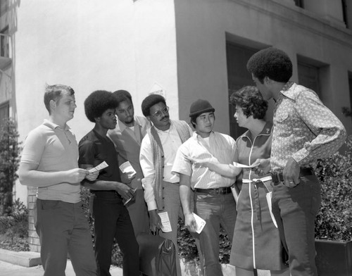 Rosalind Wiener Wyman conversing with unidentified men