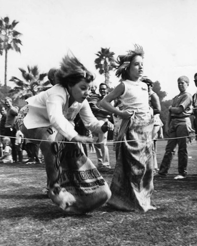 Girl's compete in potato sack race