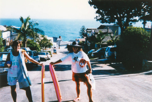 Two girlfriends with surfboards