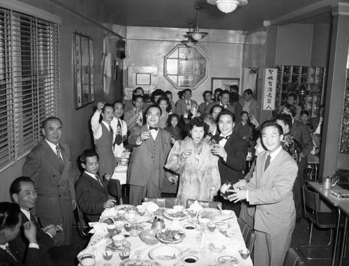 Guests toast Willie Soo Hoo at his wedding reception