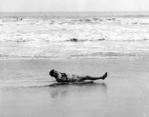 Boy sliding in surf