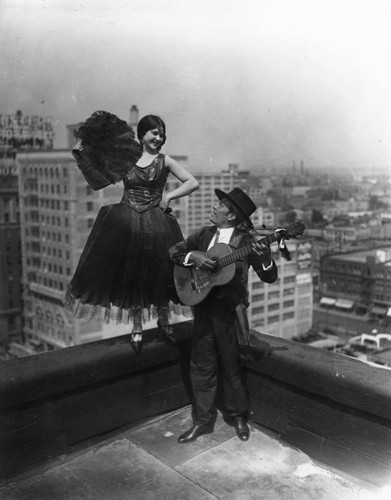 Dancer with fan on rooftop, view 3