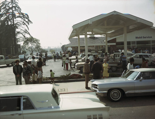 Crowd mingles at the service station