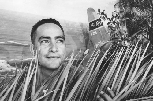 Sgt. Apo peers over banana leaves for pig baking