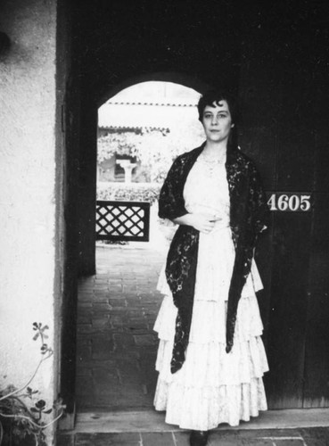 Employee in an arched entry at Casa de Adobe