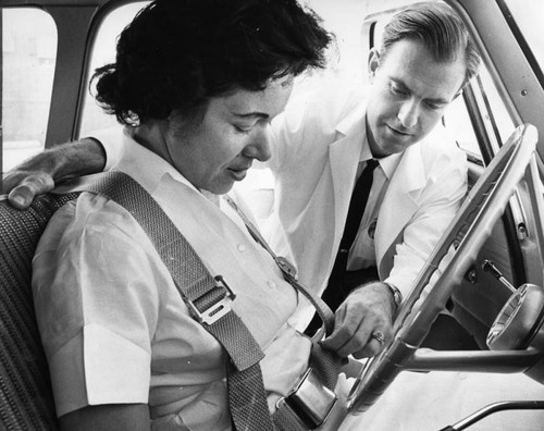 Dr. Francis Quinn demonstrates harness-seat belt