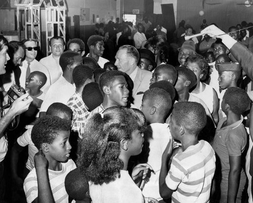 Yorty surrounded by youths at Watts Festival