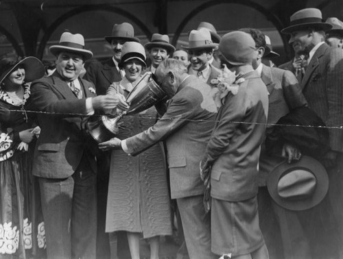 Marion Davies presents Carl Laemmle with loving cup