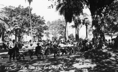 Men sitting on benches at the Plaza park