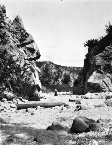 Woman standing at Devil's Gate, Pasadena