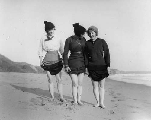 Three young women posing at the beach