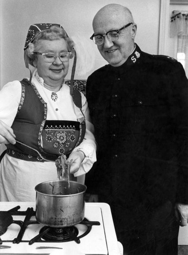 Brig. E. H. Wedler smiles approval of wife's cooking