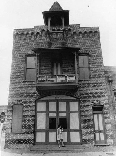 Volunteer outside historic firehouse