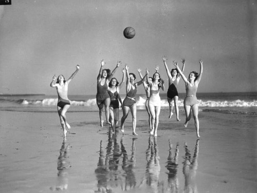 Beach beauties raising hands, view 4