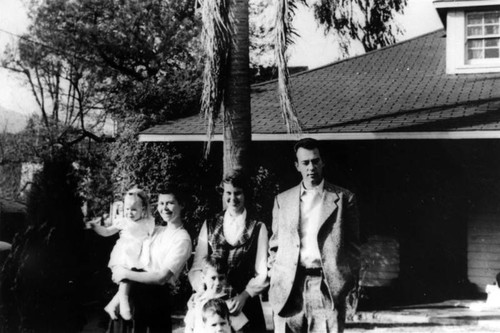 Family in front of home