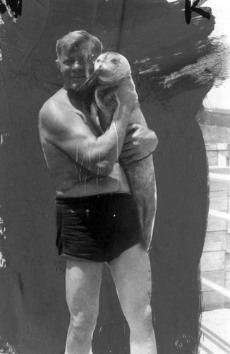 George Berger holds baby seal