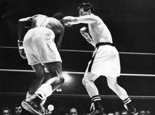 Ray Coleman (left) ducks under whistling left hook thrown by Raul Rojas in third round