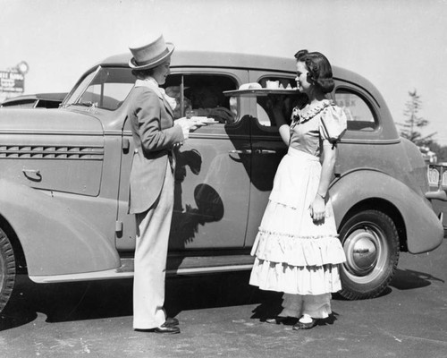 Two carhops serving at Carl's