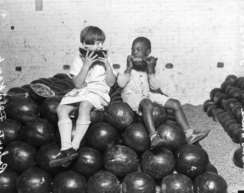 Children eating watermelons