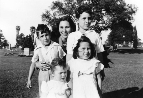 Woman with children in graveyard