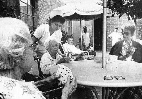 Toluca Lake home patients enjoy a card game on patio