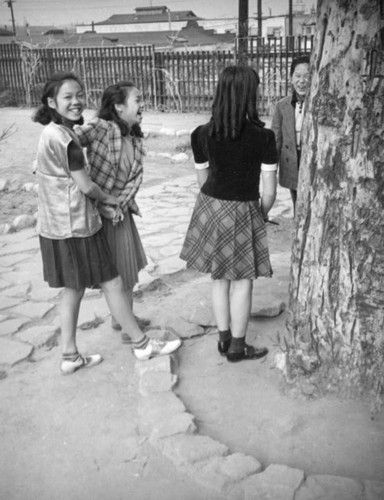 Girls laughing with a boy in China City